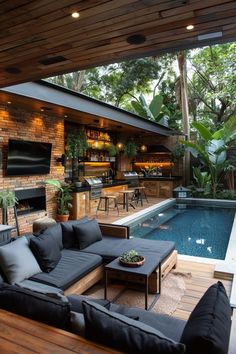 an outdoor living area with couches and tables next to a swimming pool in the background