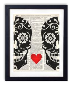 a skull with a red heart on it's face is framed in an old book