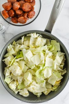 a bowl filled with lettuce and meatballs next to another bowl full of food