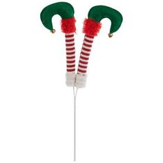 two christmas candy canes with red and green striped stockings on them, one has a santa's hat