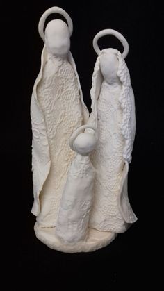 two white ceramic figurines sitting next to each other