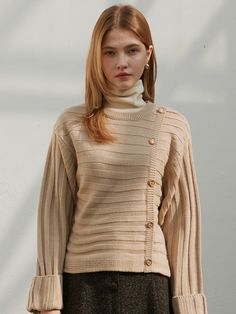 Editor's NotesThis is a knit made of soft acrylic fabric. With its soft texture and warm knitwear, you can wear it as an innerwear in winter.- Gold button- Rolled-up sleeves- Diagonal buttons are unique- Soft and warmMeasurements(in.) One Size (XS-M)- Shoulder: 19.1 in. - Chest: 18.5 in. - Sleeve length: 20.7 in. - Armhole: 11.22 in.- Total length: 20.1 in. * Modelinfo: Height 5' 57, Bust 29 in., Waist 23.5 in., Hips 34 in. * Sizing inconsistency may occur within 0.4 inchesto 1.18 inches. Composition &Care - 100% SOFT ACRYLIC- Dry Clean Only Designer - by JOORTI Beige Buttoned Sweater For Fall, Fall Beige Buttoned Sweater, Fall Beige Button Sweater, Cream Sweater With Button Closure For Winter, Beige Buttoned Tops For Winter, Cozy Beige Top With Buttons, Beige Long Sleeve Sweater With Button Closure, Beige Acrylic Cable Knit Sweater, Winter Ribbed Neutral Sweater