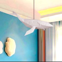 two paper fish hanging from the ceiling in a room