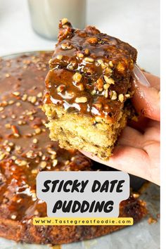 sticky date pudding being held up by someone