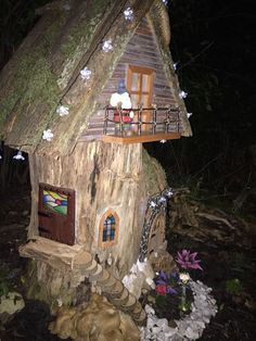 a fairy house made out of a tree stump