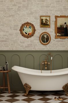 Vintage-inspired bathroom featuring a clawfoot tub with brass fixtures, green wainscoting, exposed brick wall, and checkerboard flooring. Vintage Clawfoot Tub Bathroom, Clawfoot Tub Bathroom Vintage, Checkerboard Bathroom, Green Wainscoting, Bathroom Clawfoot Tub, Bathroom With Clawfoot Tub, Clawfoot Tub Bathroom, Vintage Clawfoot Tub, Vintage Inspired Bathroom