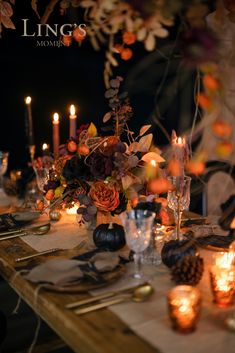 the table is set with candles, flowers and other things to decorate it for dinner