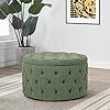 a green ottoman sitting on top of a wooden floor next to a potted plant