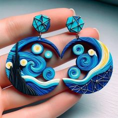 a pair of earrings that are shaped like the starry night with blue and yellow swirls