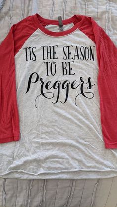 a red and white shirt that says tis the season to be preggers