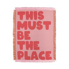 this must be the place woven throw blanket in pink with red lettering on it and fringe edges