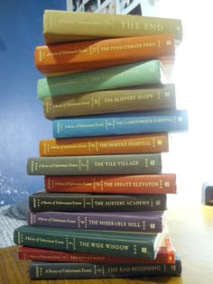 a stack of books sitting on top of a wooden table