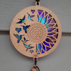 a wooden clock hanging from the side of a building with butterflies and hearts on it