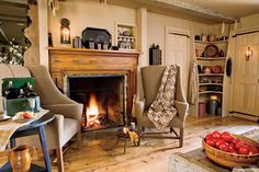 a living room filled with furniture and a fire place next to a table full of fruit