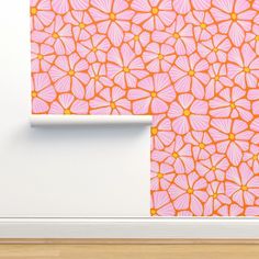 an orange and pink wallpaper with flowers on it