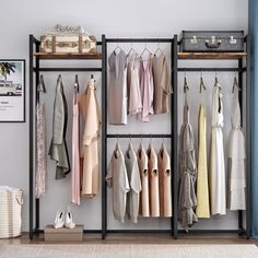 an organized closet with clothes hanging on the racks and shoes in baskets next to it