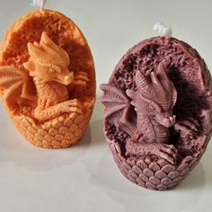 two soap molds with dragon designs on them sitting next to each other in front of a white background