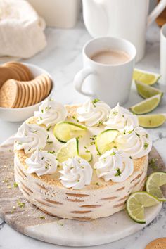 a cake sitting on top of a white plate covered in frosting and toppings