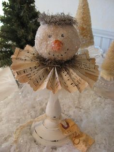 a snowman made out of old sheet music