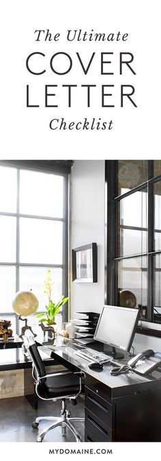 a desk with a computer on top of it in front of two windows and a plant