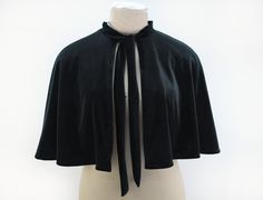 "Black velvet capelet with neck tie. The velvet or velour has a stretch so drapes very nicely, it is lined with a red tartan fabric and fastens at the neckline with a tie. It measures approx 16\" from the neckline down to the hem. I am making this cape to order, so if you would like a different colour lining, contact me before ordering and I can check what I have available." Jedi Outfit, Capelet Pattern, Cape Outfit, Velvet Cape, Black Cape, Tartan Fabric, Capes For Women, Womens Jackets, Red Tartan