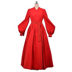 a red dress on a mannequin dummy with long sleeves and a belted waist