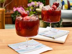 two glasses filled with liquid sitting on top of a table