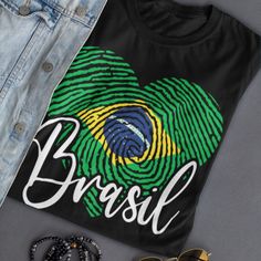 Brasil Shirt, Brasilian Shirt, Brazil Travel TShirt, Brasilian American Brasilian Flag Brasil Football Brasileira Brazilian Women Pride Celebrate your love for Brazil with our Brazilian Heartbeat t-shirt, a true symbol of pride and patriotism! This unique design showcases the Brazilian flag embedded in a heart shape, overlaid with a fingerprint pattern, representing the unity and identity of this beautiful nation. Crafted with care and passion, this t-shirt is a must-have for Brazilians and Braz Brasil Shirt, Brasil Football, Fingerprint Design, Brazilian Flag, Travel Tshirt, Brazil Travel, Flag Design, Showcase Design, Twill Tape