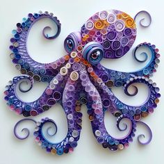 an octopus made out of buttons on a white surface with spirals in the shape of circles