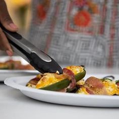 a person cutting food on a plate with a knife