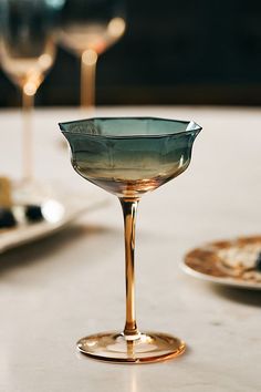 two wine glasses sitting on top of a table