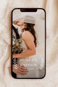 an iphone case with a wedding photo on the front and back cover, sitting on a white blanket