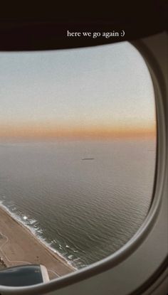 an airplane window looking out at the ocean