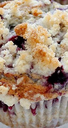 a blueberry muffin with crumbs on top