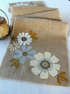 two place mats with flowers and leaves on them