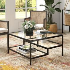 a living room scene with focus on the coffee table and chairs, which are decorated with flowers