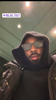 a man wearing sunglasses and a hoodie