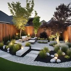 an outdoor garden with rocks and plants in the center, surrounded by wooden fences