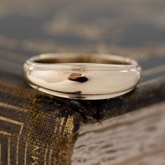 a silver ring sitting on top of a book