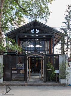 the entrance to a building that is surrounded by trees