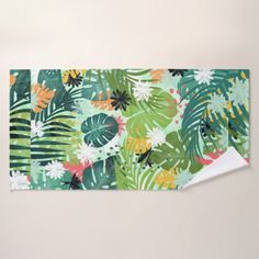 an area rug with tropical leaves and flowers on the floor in front of a white wall