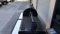 the back end of a trailer with a large metal object on it's flatbed