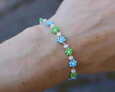 Look cute and summery with this seed bead bracelet/anklet! Perfect for you or as a gift! :)  MATERIALS - 2mm seed beads, elastic cord, silver coloured spring ring clasp LENGTH - Available in 4.5in, 5in, 5.5in, 6in, 6.5in, 7in, 7.5in, 8in, 8.5in and 9in! Please keep in mind every bracelet/anklet is handmade and unique so the size may vary slightly :) ADJUSTABILITY - Bracelet/anklet comes in 1 size only but I can add a chain extension to make it adjustable if needed! Simply message me to request this! SHIPPING - Free shipping Canada wide! Ships between 1-3 days from purchase date! Free local delivery :) CUSTOM - If you would like custom colours, please feel free to message me and I would be happy to make it!! Made with love and care in the heart of the Canadian Rocky Mountains <3 Handmade Blue Friendship Bracelets For Spring, Handmade Blue Beaded Bracelets For Spring, Handmade Turquoise Beaded Bracelets For Spring, Blue Flower Beaded Bracelets For Summer, Handmade Flower Shaped Blue Beaded Bracelets, Casual Flower-shaped Beaded Bracelets With Colorful Beads, Flower Pearl Bracelet, Flower-shaped Colorful Beads Bracelet For Beach, Multicolor Flower-shaped Beaded Bracelets For Summer