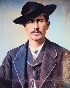 an old photo of a man in a suit and hat with a moustache