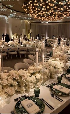 the tables are set with white flowers and candles for an elegant wedding reception at the four seasons hotel