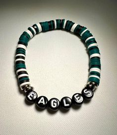 Philadelphia Eagles Heishi Bracelet.  Go Birds!! - Default wording is Eagles.  Optional Personalization is available (max 10 letters).  Letter beads can also be personalized for black bead/ white letter or white bead/ black letter. Please state any choices in the Personalization Box. -IMPORTANT Please see pics for sizing information and wrist measurements.  Please add approximately .5 inch (half inch) to wrist size for proper bracelet size. If ordering additional bracelets, please see sizing on Eagles Clay Bead Bracelet, Philadelphia Eagles Bracelet, Eagles Bracelet, Easy Origami Flower, Heishi Bracelet, Easy Origami, Clay Bead, Handmade Fashion Jewelry, Tiger Eye Beads