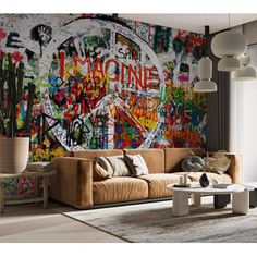 a living room filled with furniture and lots of graffiti painted on the wall behind it