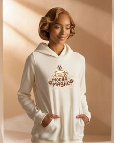 a woman wearing a white hoodie with the words mocha magic on it