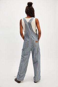 So fun in stripes, these overalls from Wrangler will turn heads with every wear. **Fit:** Relaxed, classic bib and brace silhouette **Features:** Adjustable brace straps, front functional bib pocket, yarn-dyed striped fabrication, soft rigid denim **Why We ❤ It:** Classic with cowgirl boots or off-duty with sneakers, you’ll reach for these from this season to the next. | Wrangler Stripe Straight-Leg Bib Overalls at Free People in Dark Wash, Size: XS Striped Overalls, Jean Overalls, Bib Overalls, Dungarees, Cowgirl Boots, Off Duty, Yarn Dyeing, Boho Outfits, Overalls