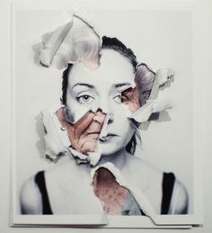 a woman's face with torn up pieces of paper